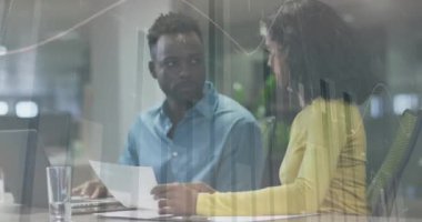 Animation of financial data processing over diverse business people in office. Global business, finances, computing and data processing concept digitally generated video.