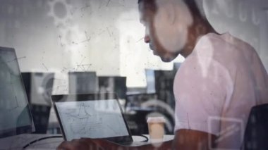 Animation of icons and connections over african american businessman using laptop in office. Global business, finances, computing and data processing concept digitally generated video.
