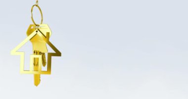 Animation of gold key with house keychain on grey background. Abstract background, pattern and movement concept, digitally generated video.