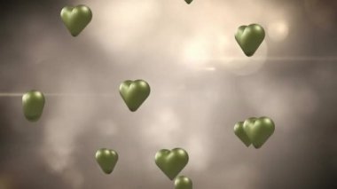 Animation of gold hearts over light spots and smoke. Valentine's day, love and celebration concept digitally generated video.