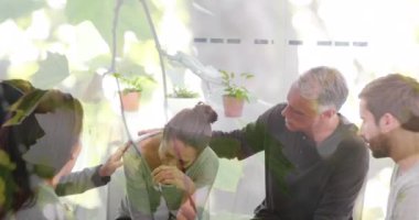 Animation of leaves over diverse people participating in group therapy. Mental health, therapy and healthcare concept digitally generated video.
