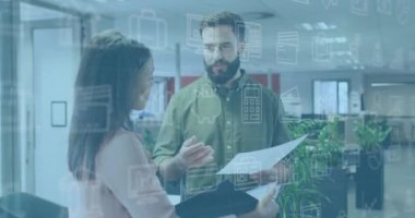 Animation of icons and data processing over diverse business people in office. Global business, finances, computing and data processing concept digitally generated video.