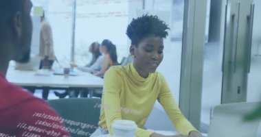 Animation of financial data processing over diverse business people in office. Global business, finances, computing and data processing concept digitally generated video.