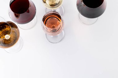 Glasses with red, rose and white wine on white background, with copy space. Wine week, drink and celebration concept.