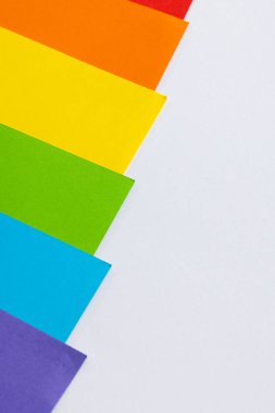 Close up of rainbow coloured cards with copy space on white background. Pride month, equality, lgbt and human rights concept.