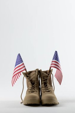 Military boots with flags of usa on white background, with copy space. Memorial day, patriotism and celebration concept.