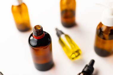 Image of glass bottles with pumps and copy space on white background. Plastic free beauty, health and beauty, sustainability concept.