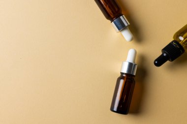 Image of three bottles with pumps and copy space on yellow background. Plastic free beauty, health and beauty, sustainability concept.