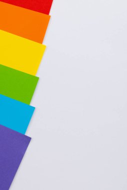 Close up of rainbow coloured cards with copy space on white background. Pride month, equality, lgbt and human rights concept.