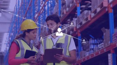Animation of network of connections with icons over diverse workers in warehouse talking. Global business and digital interface concept digitally generated video.