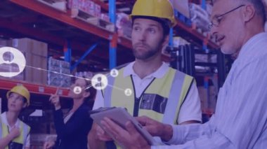Animation of network of connections with icons over diverse workers in warehouse talking. Global business and digital interface concept digitally generated video.