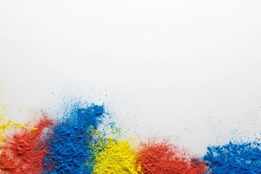 Close up of multi coloured powder and copy space on white background. Holi festival, colour, hindu tradition and celebration concept.