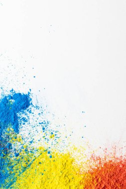 Close up of multi coloured powder and copy space on white background. Holi festival, colour, hindu tradition and celebration concept.