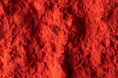 Close up of red powder background, with copy space. Holi festival, colour, hindu tradition and celebration concept.