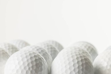 Close up of white golf balls with copy space on white background. Golf, sports and competition concept.