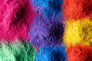 Close up of multi coloured powder with copy space. Holi festival, colour, hindu tradition and celebration concept.