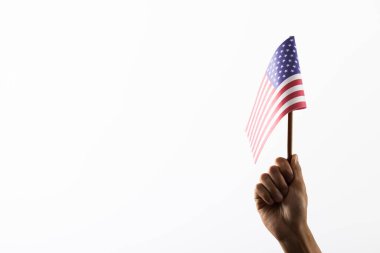 Hand holding flag pole of usa on white background with copy space. Memorial day, patriotism and celebration concept.