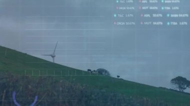 Animation of statistical and stock market data processing over spinning windmill against grey sky. Global economy and renewable energy technology concept