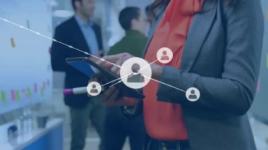 Animation of network of connections with icons over biracial businesswoman using tablet. Global networks, business, finances, computing and data processing concept digitally generated video.