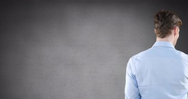 Animation of rear view of caucasian man touching invisible screen on grey background with copy space. Business technology concept