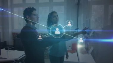 Animation of network of profiles over diverse man and woman discussing over a whiteboard at office. Global networking and business technology concept