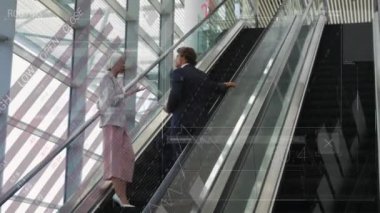 Animation of data processing over diverse man and woman discussing on escalator. Business data technology concept