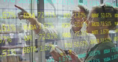 Animation of trading board and mathematical sums over caucasian coworkers discussion reports. Digital composite, multiple exposure, stock market, office, business, teamwork and technology concept.