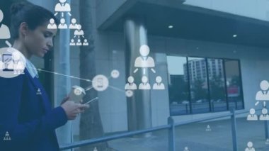 Animation of connected icons over caucasian businesswoman walking using cellphone and holding coffee. Digital composite, multiple exposure, communication, beverage and technology concept.