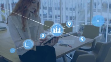 Animation of network of digital icons against caucasian woman using digital tablet at office. Global networking and business technology concept