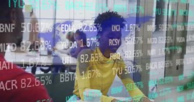 Animation of trading board, map against african american female manager talking with male coworker. Digital composite, multiple exposure, stock market, global, office, discussion and technology.