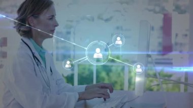 Animation of network of profile icons over caucasian female doctor using computer at hospital. Global networking and medical healthcare technology concept