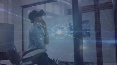 Animation of network of connections over caucasian man wearing vr headset at office. Global networking and business technology concept