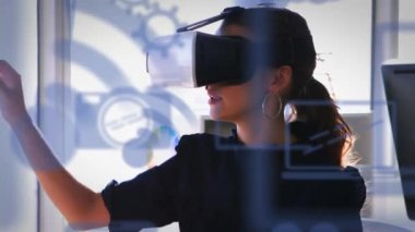 Animation of multiple digital icons floating over caucasian woman wearing vr headset at office. Computer interface and futuristic business technology concept