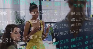 Animation of trading board over diverse female sharing ideas with coworkers in meeting at office. Digital composite, multiple exposure, stock market, business, teamwork and technology concept.