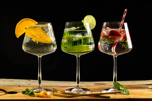 Three Glasses Water Fruit Wooden Board Black Background Cocktail Day — Stok fotoğraf
