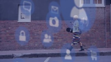 Animation of social media icons over biracial woman walking and using smartphone. Global social media and digital interface concept digitally generated video.