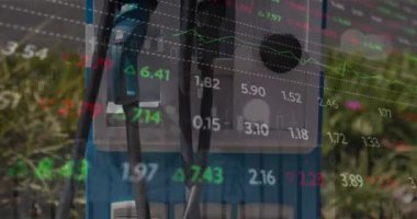 Animation of financial data processing over petrol pump. Global business, finances, computing and data processing concept digitally generated video.