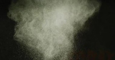 Video of green coloured powders with copy space on black background. Holi festival, hindu tradition and celebration concept