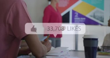 Animation of like icon with growing number over diverse business people having meeting at office. Global business, finances and digital interface concept digitally generated video.
