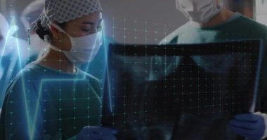 Animation of cardiograph over diverse surgeons working at hospital. Medicine, healthcare and digital interface concept concept digitally generated video.