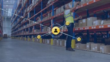 Animation of network of connections with icons over man working in warehouse. Global shipping, business, finances, computing and data processing concept digitally generated video.