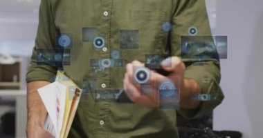 Animation of data processing with scope scanning over caucasian businessman working at office. Global business, finances and digital interface concept digitally generated video.