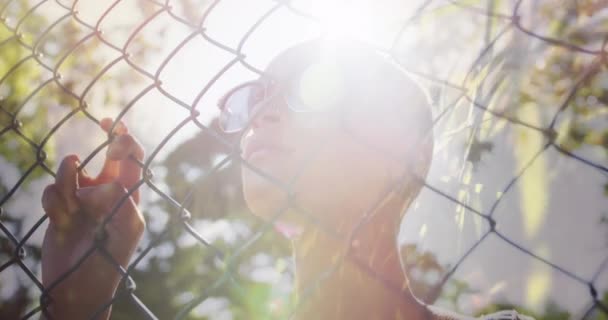 Animation Grass Light Trails Biracial Woman Wearing Sunglasses Standing Fence — Stock Video