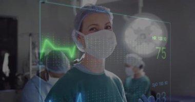 Animation of cardiograph over diverse surgeons operating on patient at hospital. Medicine, healthcare and digital interface concept concept digitally generated video.
