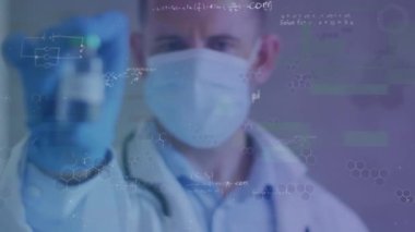 Animation of caucasian male doctor holding vaccine and data processing over blue background. Global medicine, digital interface, computing and data processing concept digitally generated video.