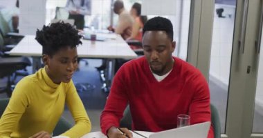 Animation of moving columns over diverse business people working at office. Global business, finances and digital interface concept digitally generated video.