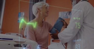 Animation of cardiograph over diverse doctor and patient at hospital. Medicine, healthcare and digital interface concept concept digitally generated video.