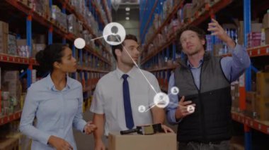 Animation of network of connections with icons over diverse workers talking in warehouse. Global shipping, business, finances, computing and data processing concept digitally generated video.