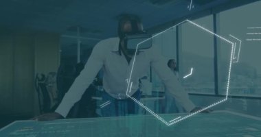 Animation of chemical structures over african american businessman wearing vr headset at office. Medical research and business technology concept