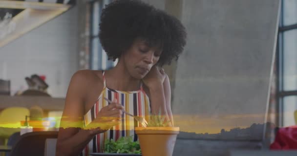 Animación Del Paisaje Del Atardecer Sobre Mujer Afroamericana Comiendo Ensalada — Vídeo de stock